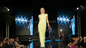 Women in yellow dress walking the runway