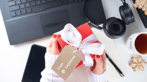 Holiday gift and branded headphones next to laptop